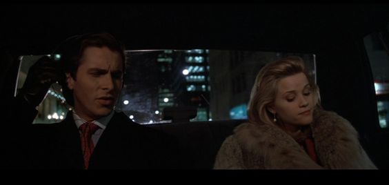 An screenshot of the American Psycho, where Patrick Bateman talks to his fiance in a taxi cab at night.