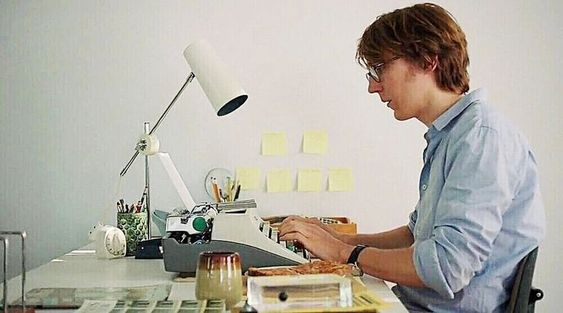 An screenshot of the movie Ruby Sparks, as a character sits at a typewriter in an all-white room