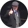 An blurry image of Cillian Murphy wearing a 1920s ganster outfit holding a thumb up