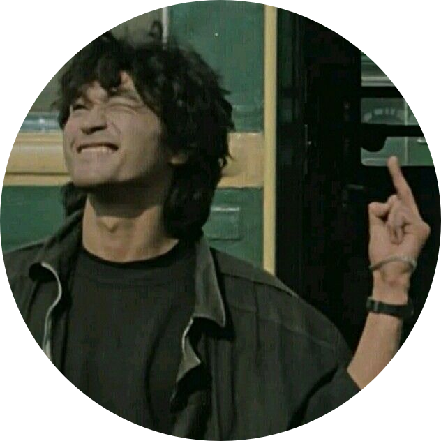 a candid photo of Viktor Tsoi (the leader singer of the band Kino) posing with a punk hand gesture and shut eyes